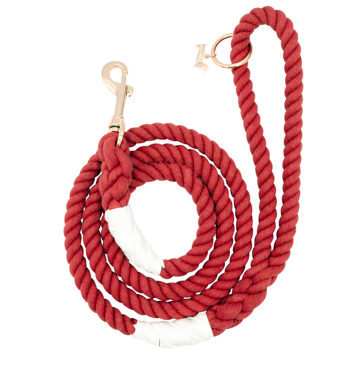 The Sassy Woof Dog Rope Leash - Crimson is a coiled red cotton leash with white accents, rose gold clasp hardware, and a gold charm on the handle loop, shown on a white background.