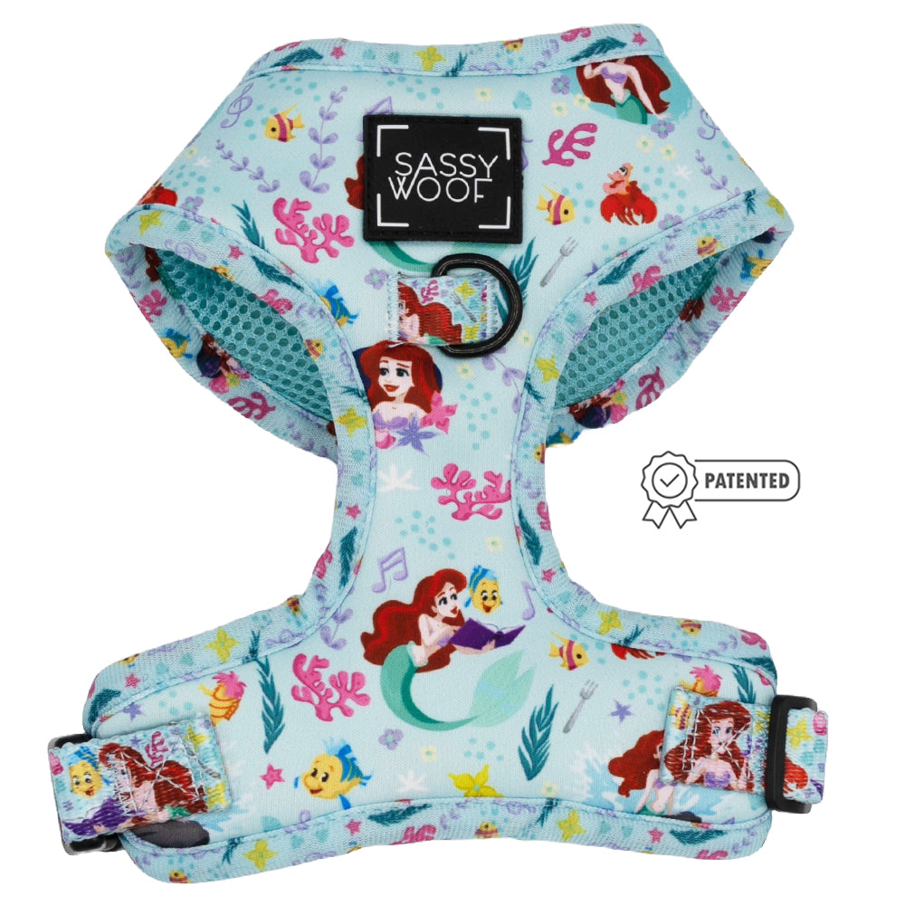 The Sassy Woof Dog Two Piece Bundle - Disney's Ariel is a light blue adjustable harness with The Little Mermaid design featuring Ariel, Flounder, sea creatures, pink coral, a black Sassy Woof logo, and patented badge—ideal for puppy growth pawtection plan.