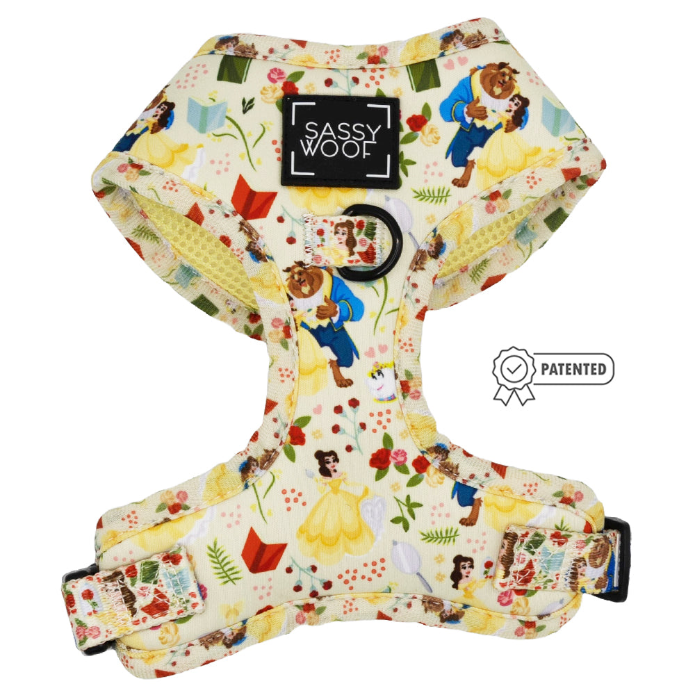 The Sassy Woof Dog Two Piece Bundle - Disney's Belle features a cream harness with Beauty and the Beast designs, including Belle, the Beast, books, and roses. Includes black D-ring, buckle, Puppy Growth Pawtection Plan coverage, and patented icon.