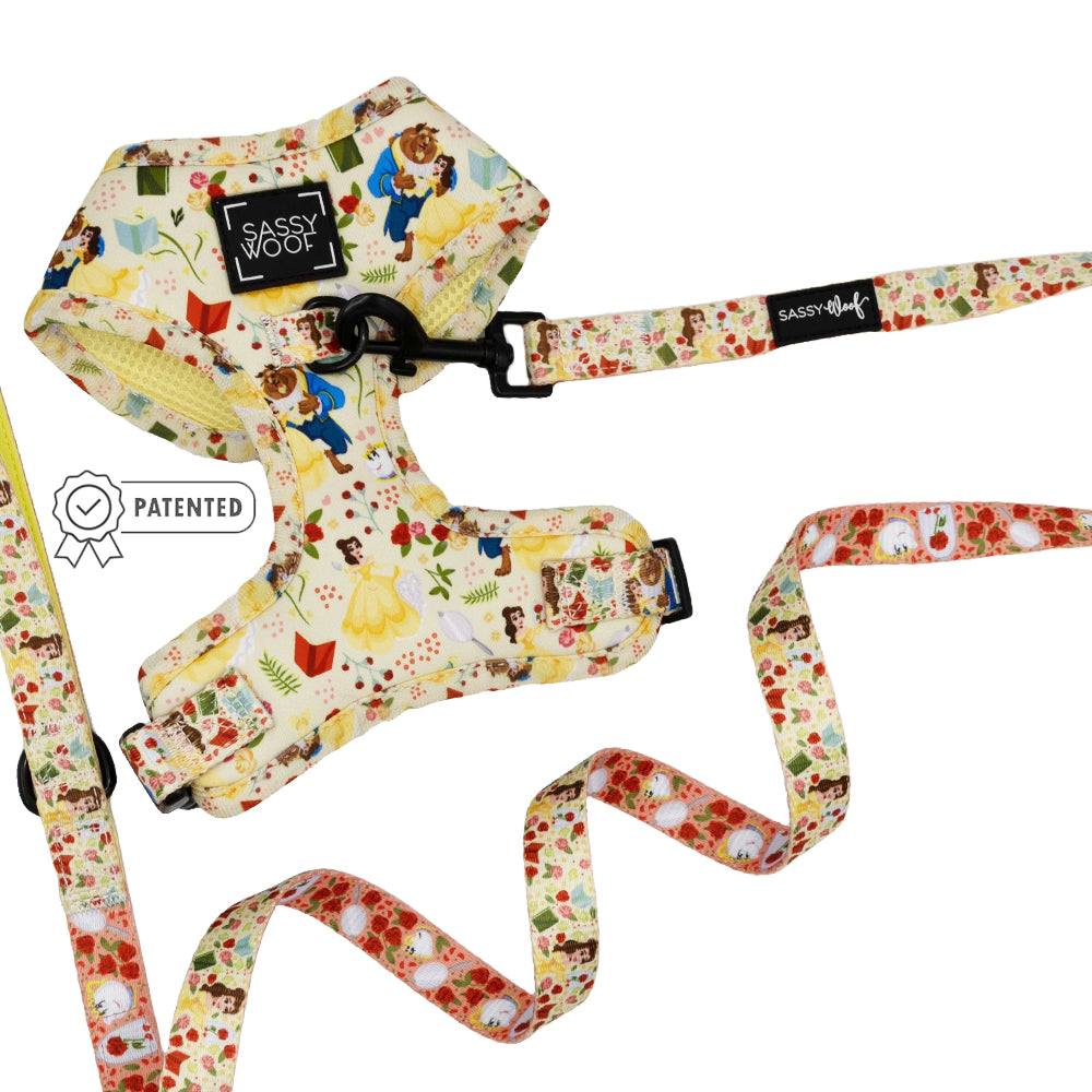 The Sassy Woof Dog Two Piece Bundle – Disney's Belle features a floral yellow harness and matching leash for dogs, each with playful Belle illustrations, Sassy Woof labels, and a PATENTED badge beside the adjustable harness.