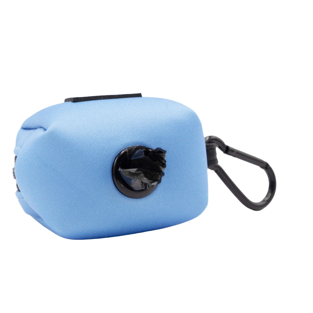 The Dog Waste Bag Holder - Hydrangea by Sassy Woof features blue fabric with a black carabiner and visible bag, perfect for those who love pastel pet accessories.