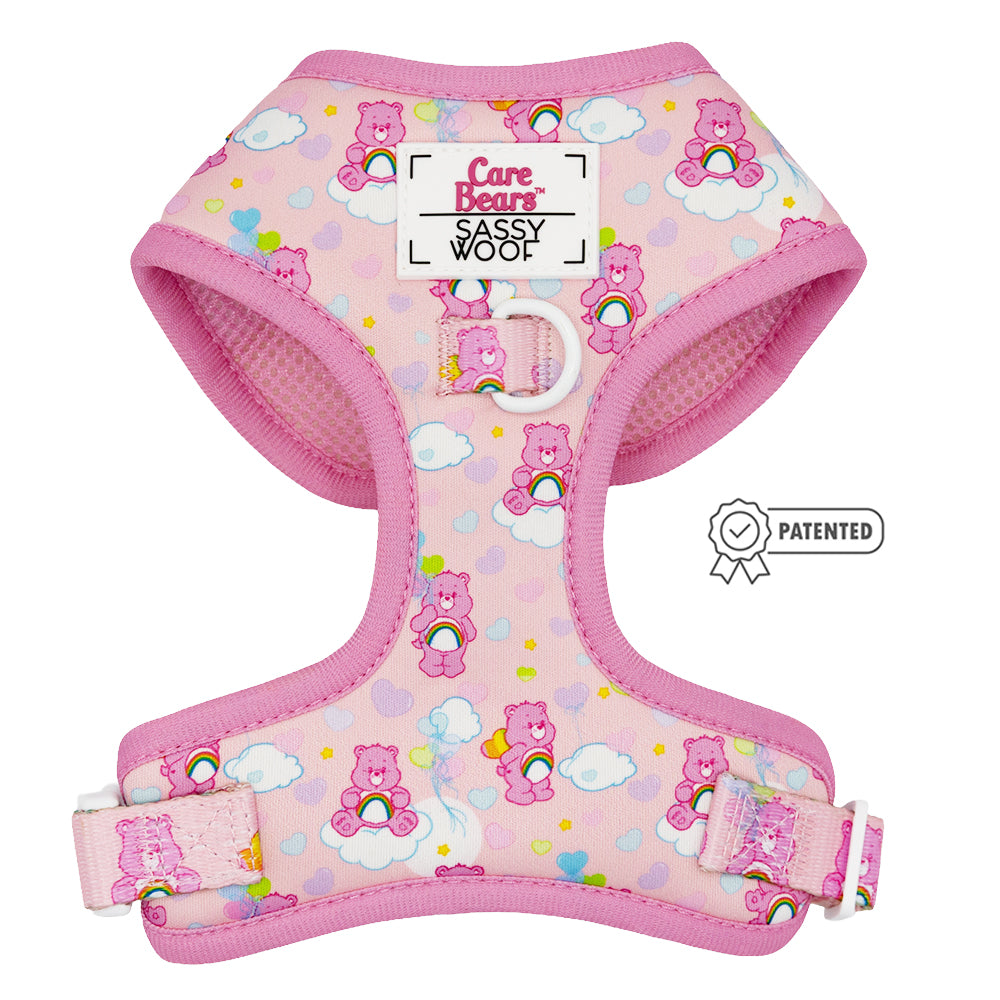 The Sassy Woof Dog Four Piece Bundle - Care Bears™ Cheer Bear features a pink adjustable harness with rainbow, cloud, and heart designs plus a patented symbol—perfect for pups on the Puppy Growth Pawtection Plan.
