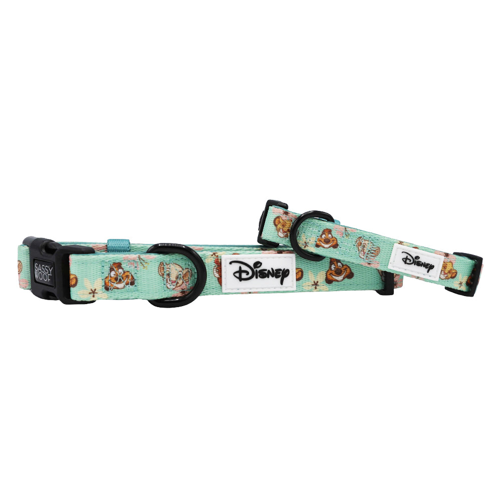 Two teal-colored Sassy Woof dog collars from the Disney’s The Lion King Wild Kingdom collection, featuring black plastic buckles and a white Disney logo tag. Perfect for pairing with an adjustable Disney dog harness, the collars are displayed on a white background.