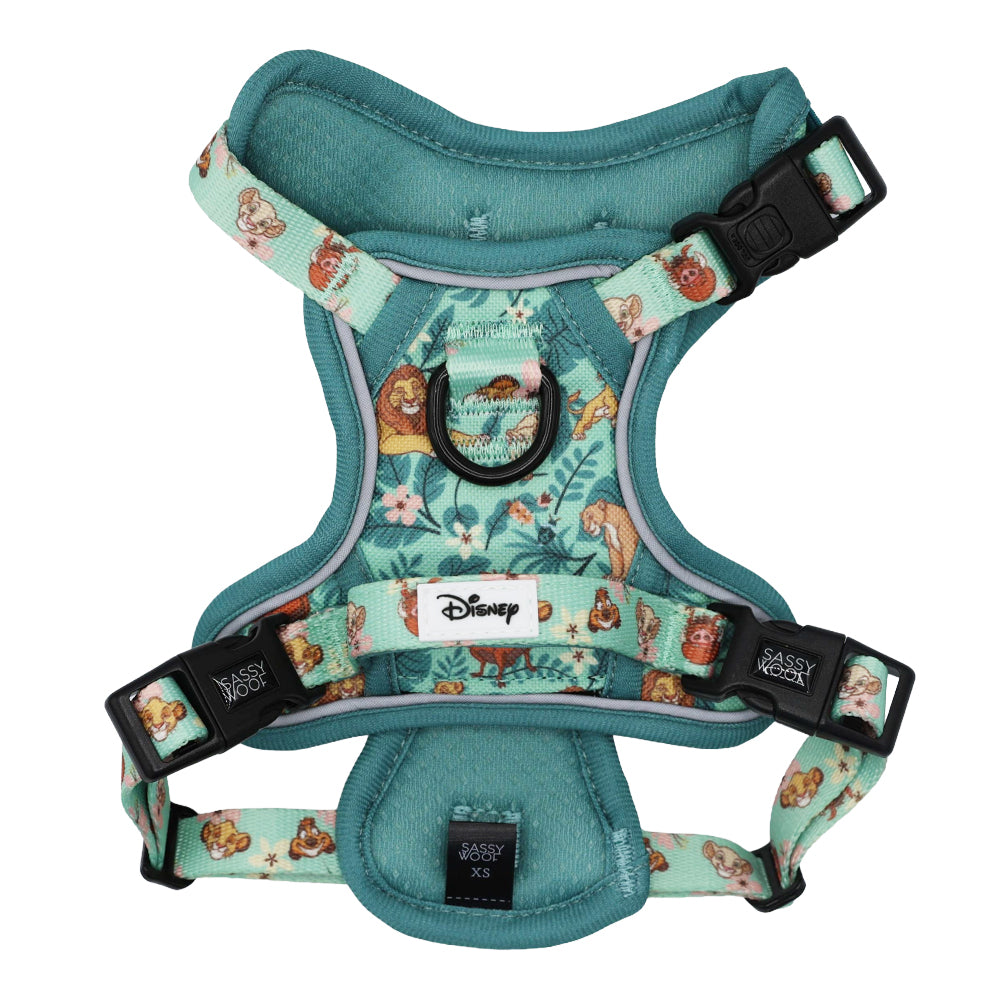 Introducing the Dog Step-in Harness - Disney’s The Lion King Wild Kingdom by Sassy Woof—a teal harness adorned with beloved characters and vivid floral designs from Disney’s The Lion King. Featuring adjustable straps, sturdy black plastic buckles, and signature Sassy Woof and Disney labels on the front, this harness blends playful style with everyday comfort for your pup.