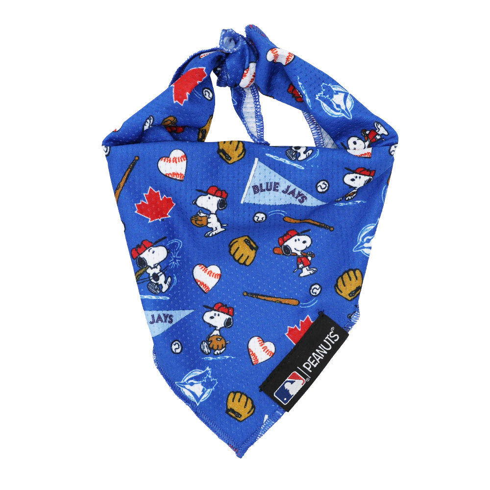 The Sassy Woof Dog Bandana - MLB™ x Peanuts™ Toronto Blue Jays™ features Snoopy in baseball poses, team logos, bats, gloves, balls, and maple leaves. A small MLB Peanuts tag accents this blue cooling mesh bandana.