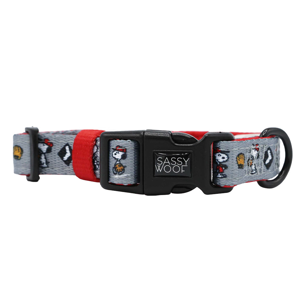 The Sassy Woof Dog Collar - MLB™ x Peanuts™ Chicago White Sox™ is a gray and red adjustable collar with a Snoopy and Woodstock pattern, featuring a black plastic Sassy Woof buckle and metal ring for easy attachment. Perfect for fans!.