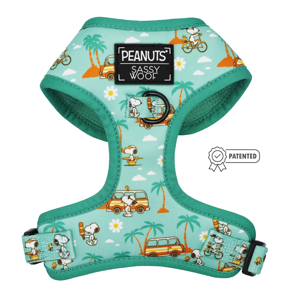 The Sassy Woof Dog Adjustable Harness - Peanuts™ Road Tripping features Snoopy and Woodstock on bikes and vans with palm trees and daisies. A patch reads "PEANUTS SASSY WOOF" with a patented icon—perfect for adventurous dogs.