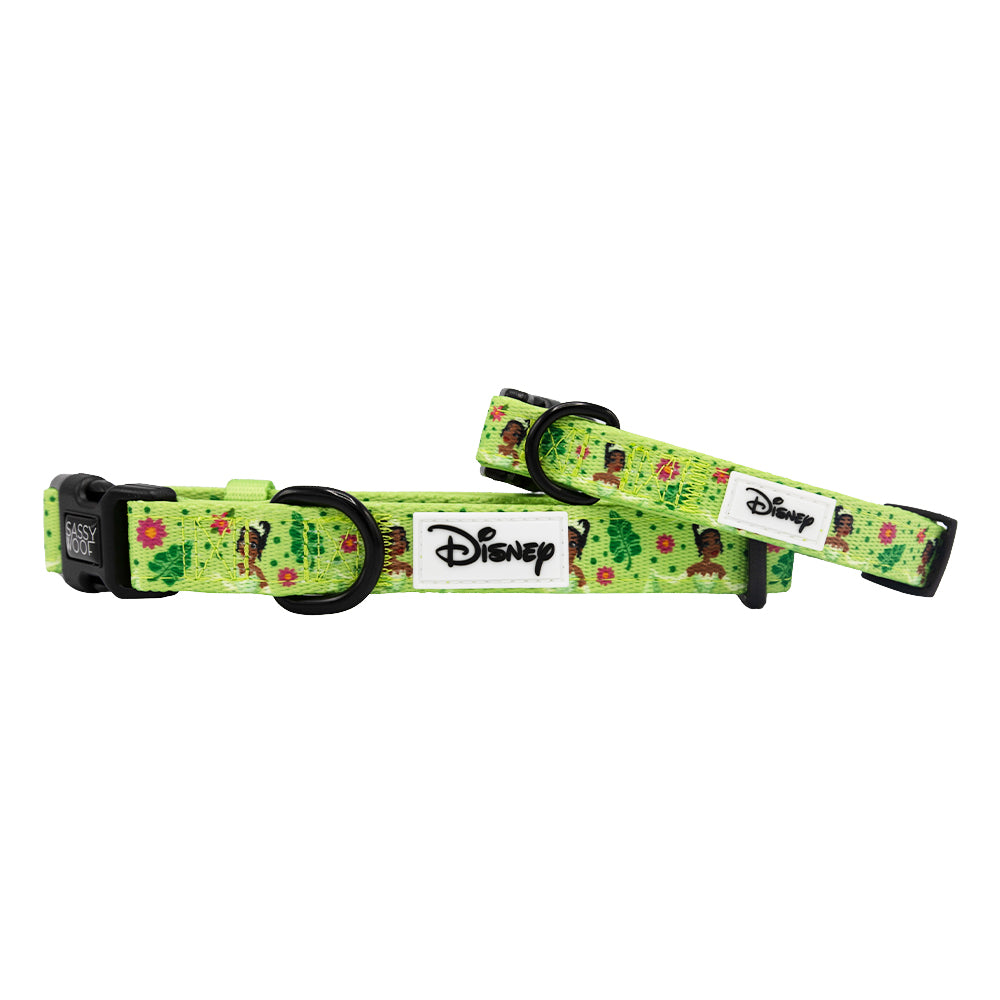 Two green Sassy Woof dog collars—Disney's Tiana edition—with black plastic buckles, metal rings, and a floral pattern inspired by The Princess and the Frog. Perfect match for a Princess and the Frog dog harness.