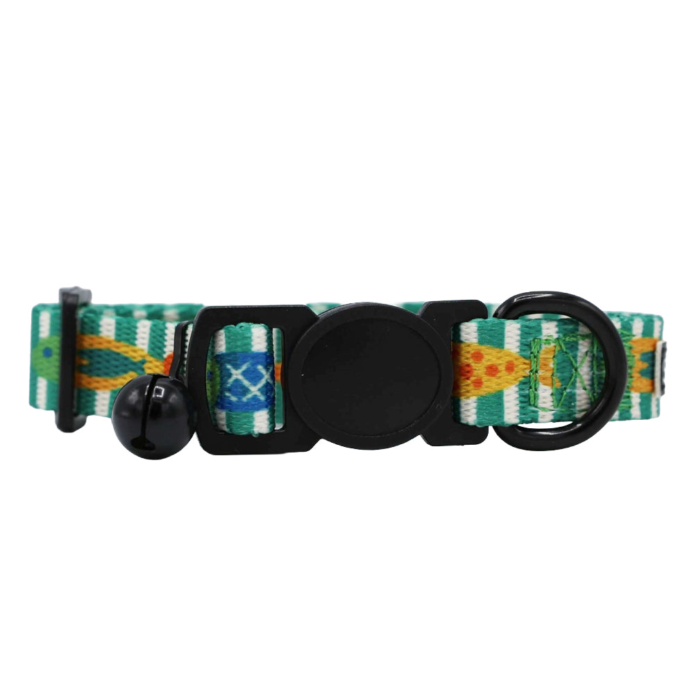 The Sassy Woof Cat Collar - Portofino features green, yellow, and blue patterned fabric, a black plastic buckle, black metal D-ring, and a small black bell for added style.