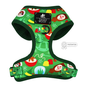 The Dog Adjustable Harness - Elf™ by Sassy Woof features festive holiday prints with ornaments, snowflakes, and mugs. This no pull dog harness offers adjustable straps, dark green trim, Sassy Woof branding, and a patented badge on the right.