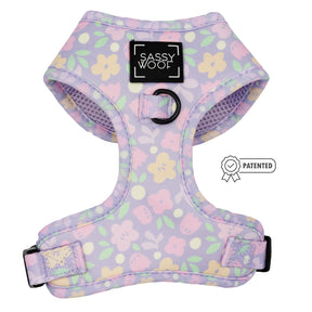 The Sassy Woof Dog Adjustable Harness - Fleur de Sass features pastel florals, black adjustable straps, a central black ring, and a front label. A Patented badge highlights this no pull dog harness.