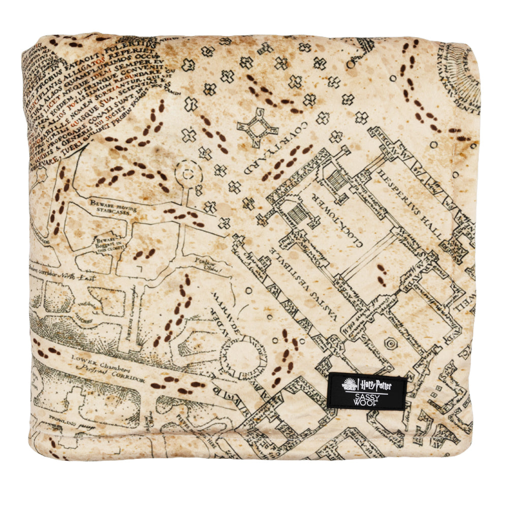 The Sassy Woof Pet Blanket - Harry Potter™ Marauder's Map™ features a detailed map design with footprints and a black Harry Potter label on the corner, inspired by the iconic wizarding world.