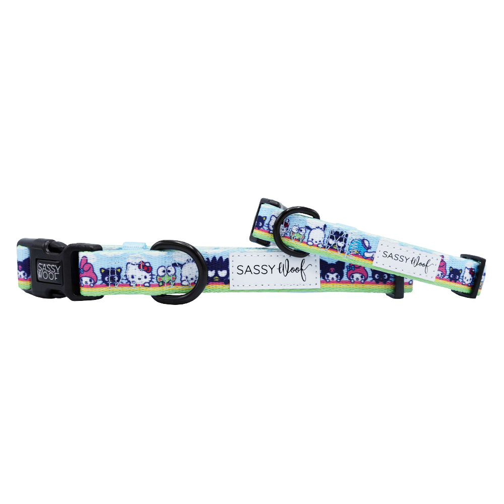 The Sassy Woof Dog Collar - Hello Kitty® & Friends In the Sky is a colorful, adjustable collar with cartoon designs on light blue, featuring a black buckle, D-ring, and white Sassy Woof label—perfect for stylish pups.