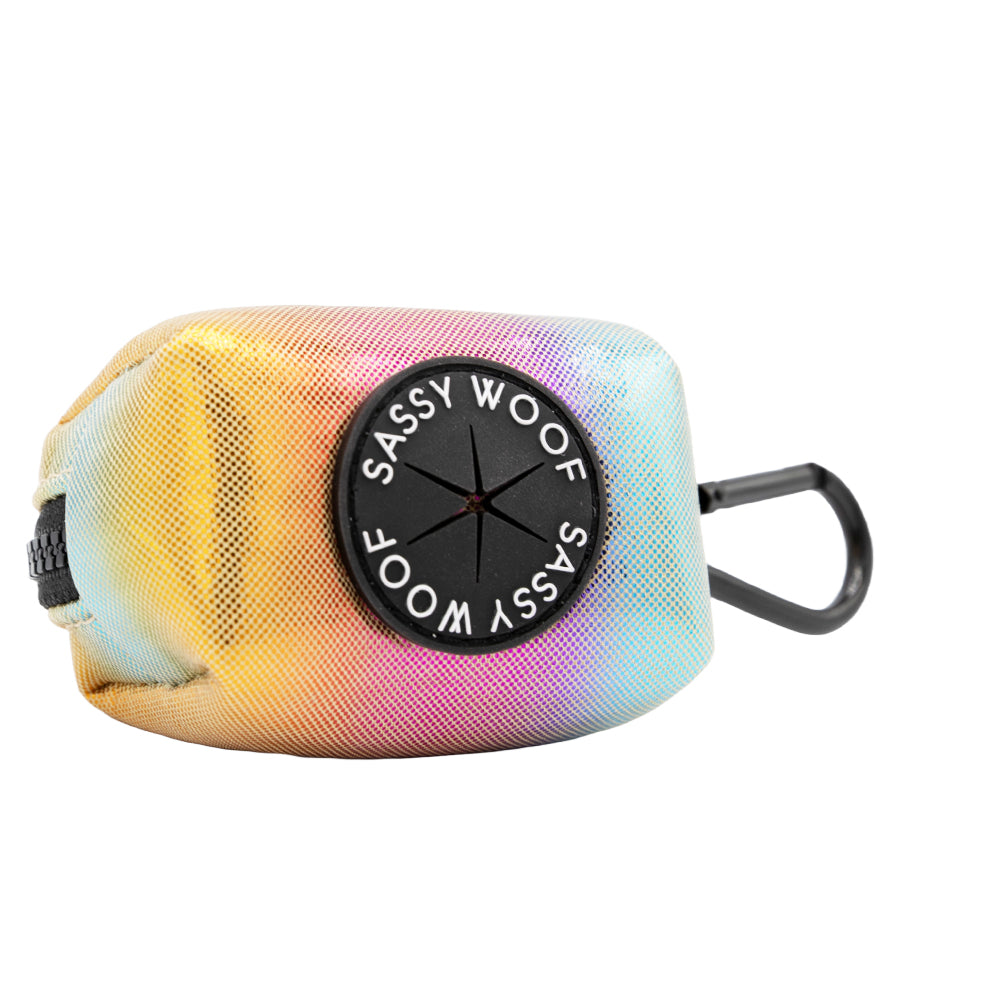The Sassy Woof Dog Waste Bag Holder - The Night Life is a small, rainbow neoprene bag with a black dispenser and clip, perfect for carrying dog waste bags and pairing with matching harnesses or other disco dog accessories.