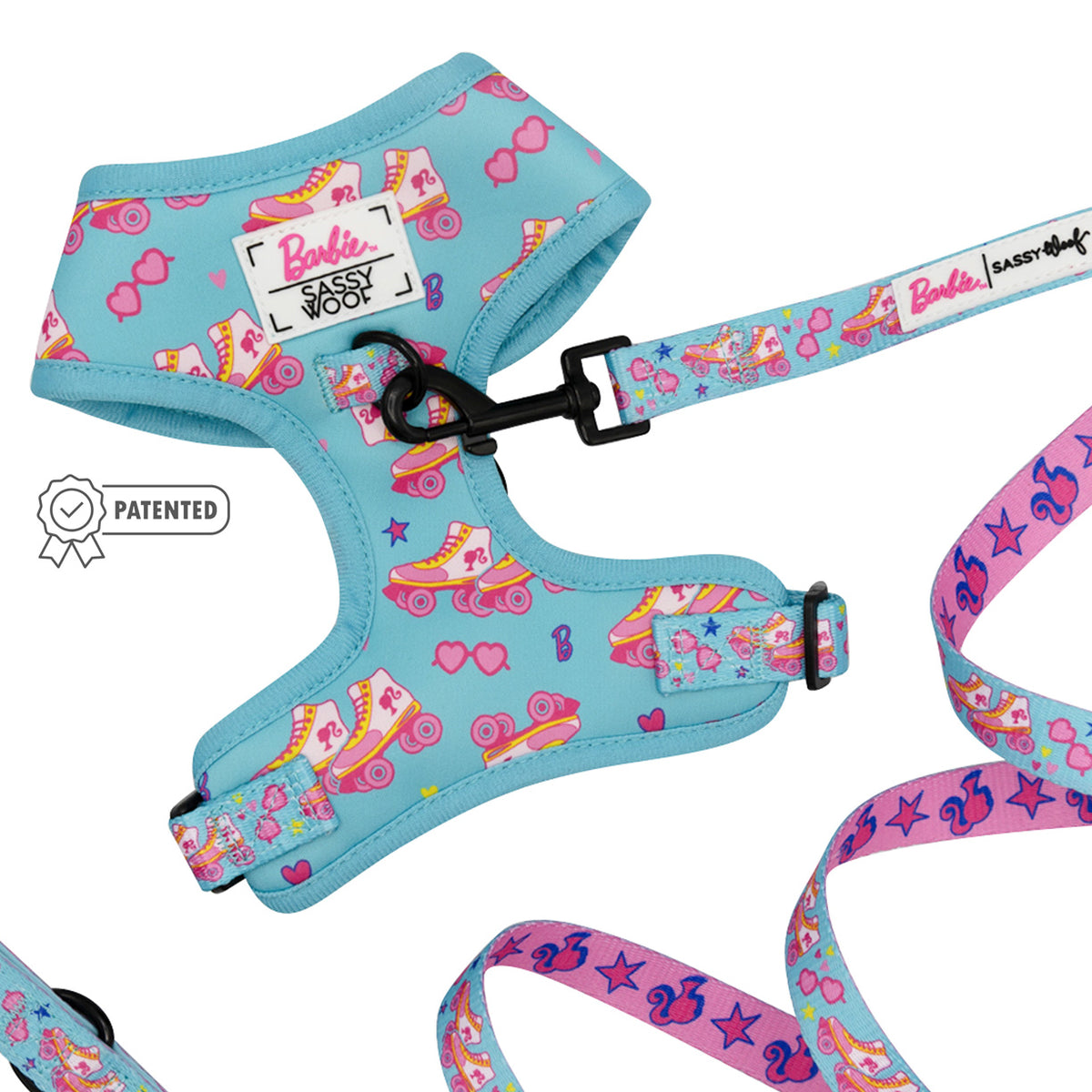 The Sassy Woof Dog Two Piece Bundle - BARBIE™ On a Roll features a blue harness and leash with pink skate and heart designs, colorful patterns, a signature icon, and stylish Barbie branding.