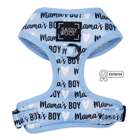 The Sassy Woof Dog Adjustable Harness - Mama's Boy features a light blue no-pull design with black trim, repeated "Mamas BOY" text, white heart illustrations, a front Sassy Woof label, and a patented badge on the right.
