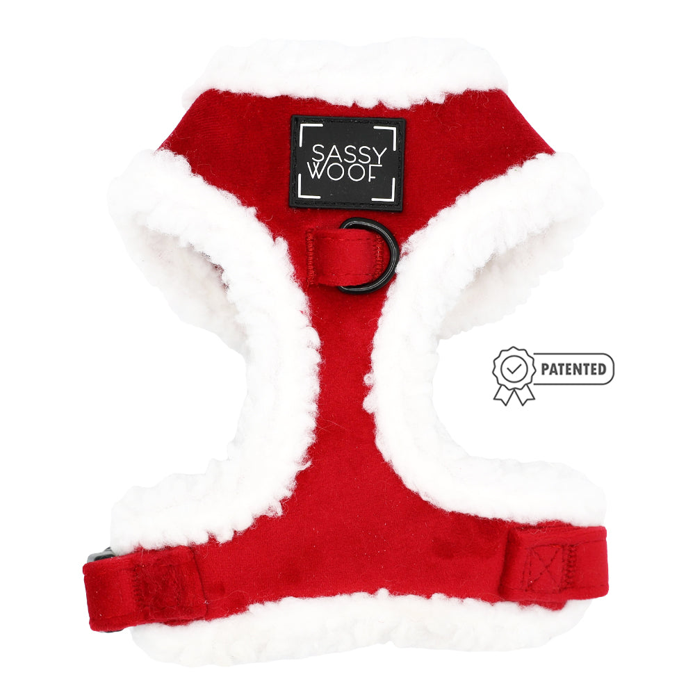 The Sassy Woof Dog Adjustable Harness - Naughty features a red and white sherpa design with a back label, leash ring, and patented badge icon—ideal for those wanting cozy holiday accessories for their dog.