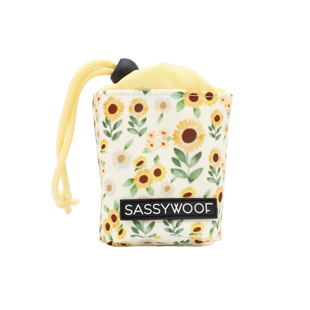 The Sassy Woof Treat Pouch - Sunflower Dreams is a small, yellow drawstring pouch with a sunflower pattern—ideal for pet owners to carry treats during dog training sessions.