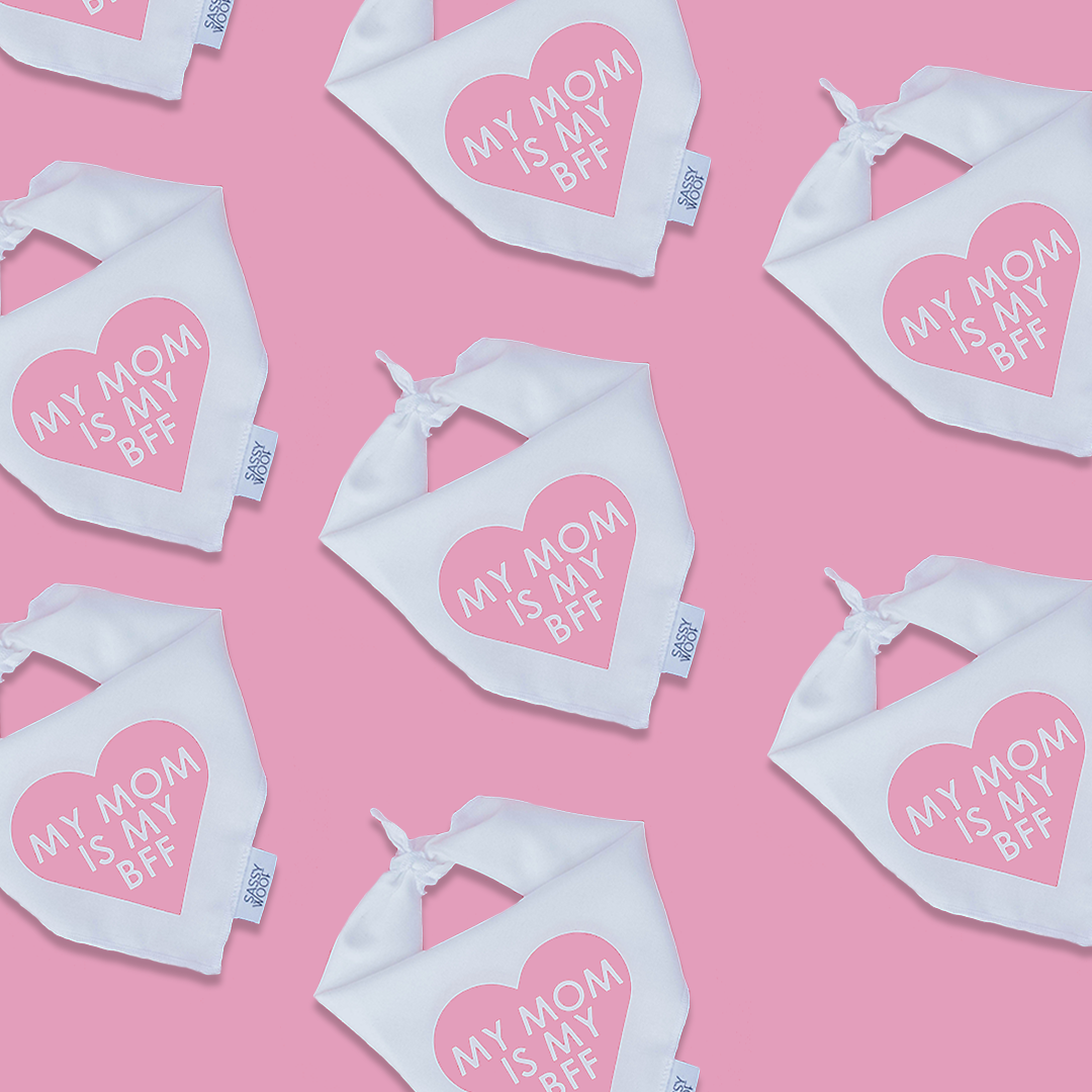 Sassy Woof's Dog Bandana - My Mom is my BFF (PINK) pairs perfectly with white baby bibs featuring pink hearts and "MY MOM IS MY BFF" text, making an adorable matching set for pets and babies.
