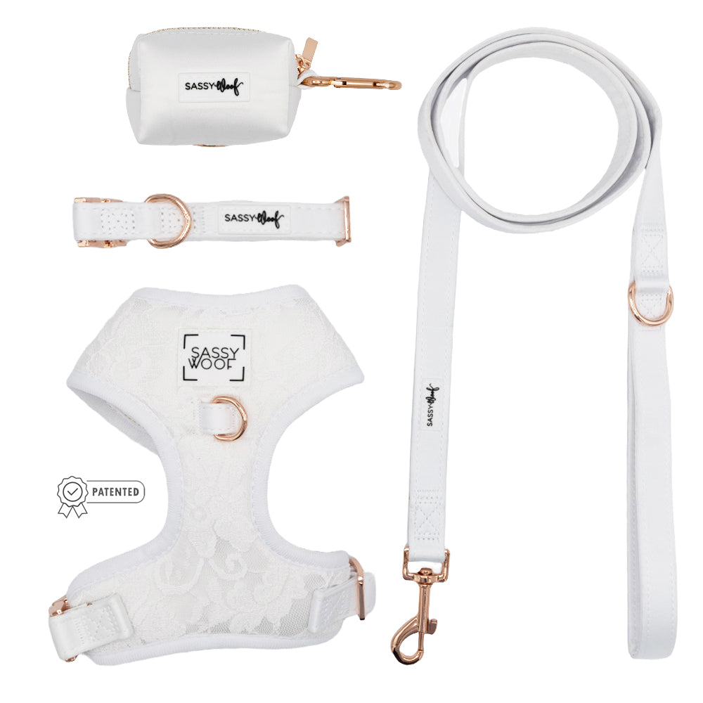 The Sassy Woof Dog Four Piece Bundle - Pup of Honor features a white satin harness with rose gold hardware, leash, collar, and small pouch—all shown on a plain white background.