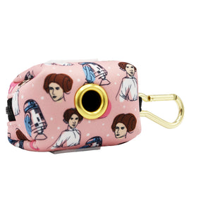 The Sassy Woof Dog Waste Bag Holder - STAR WARS™ Princess Leia is a pink rectangular holder with a gold clip, cartoon Leia and R2-D2 images, and a circular opening on one side.