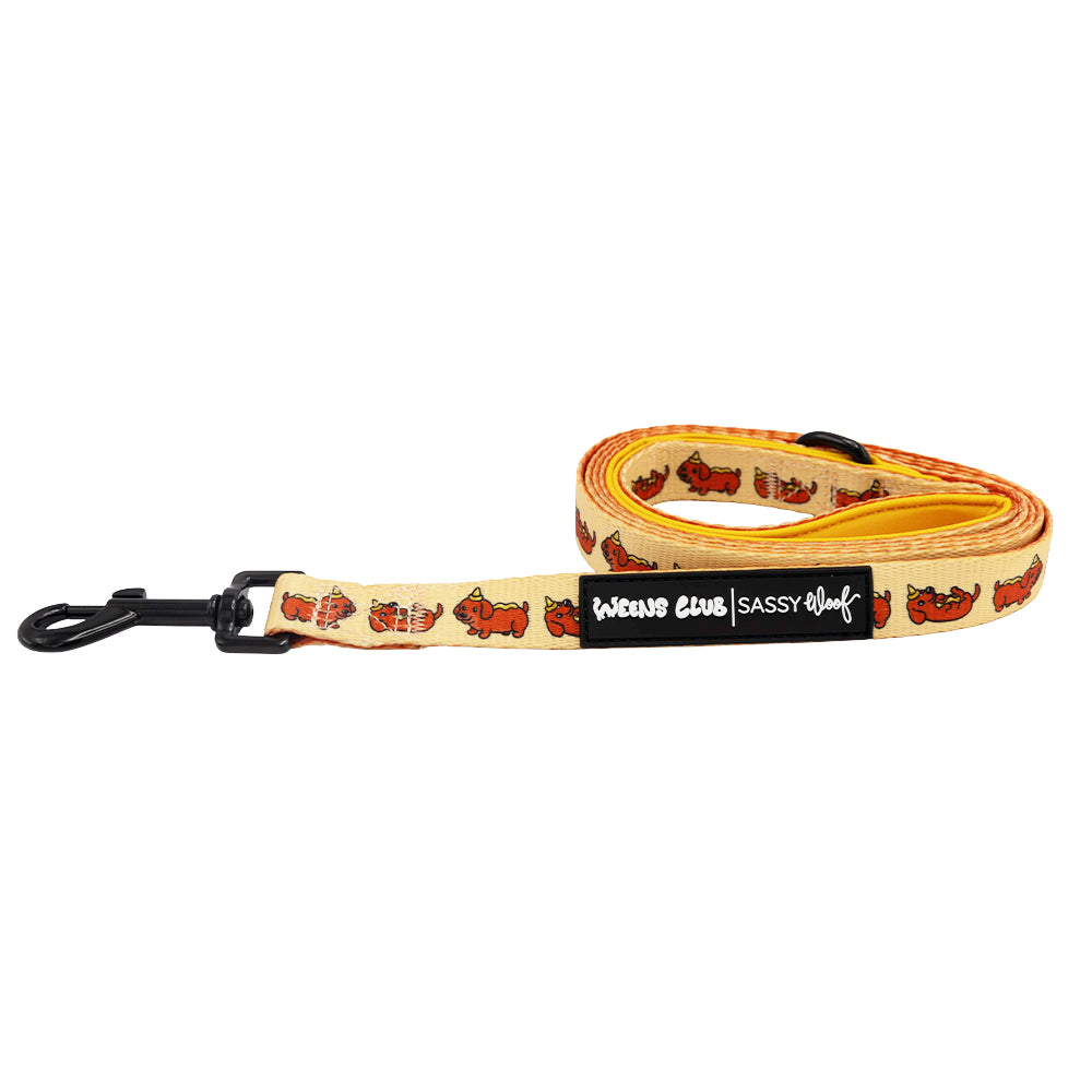 The Dog Leash - Hot Dawg by Sassy Woof features a yellow design with cartoon brown dachshunds, a black metal clasp, and a "BONE CLUB | SASSY WOOF" label—ideal for the weenie-inspired collection or pairing with an adjustable harness.