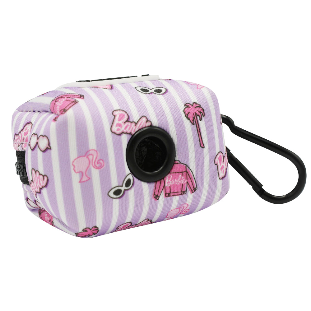 The Sassy Woof Dog Waste Bag Holder - BARBIE™ Closet Goals features pink and white stripes with Barbie icons, a black carabiner clip, and a round opening for easy bag dispensing.