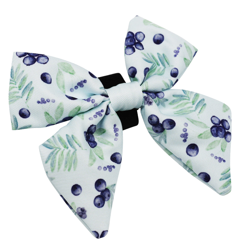 The Sassy Woof Dog Sailor Bow - Berry Sassy features white fabric with green leaves and purple berries on a black clip—ideal for pairing with a matching leash or dog collar for a coordinated look.