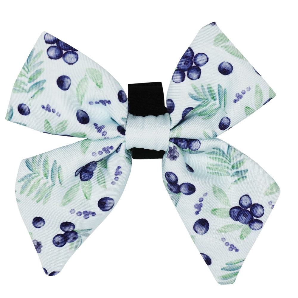 The Sassy Woof Dog Sailor Bow in Berry Sassy features a white base, black center, and a blue berry and green leaf pattern—perfect for pairing with the matching leash for a coordinated look.