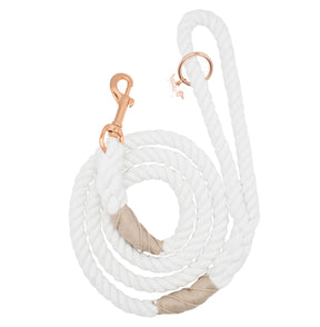 The Sassy Woof Dog Rope Leash - Dove features elegant rose gold hardware, a coiled white cotton design with tan accents, and includes a metal clasp and ring at one end.