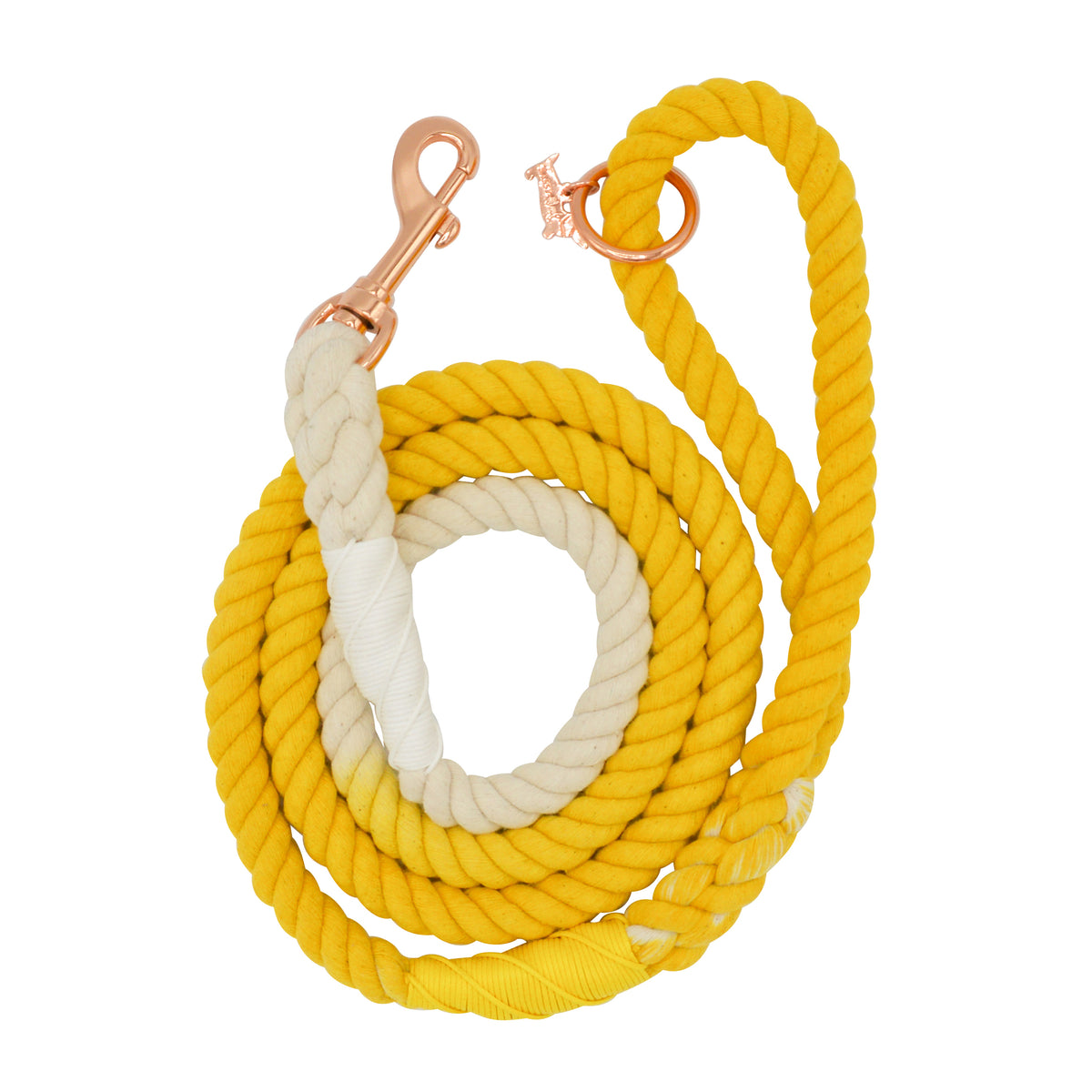 The Sassy Woof Dog Rope Leash - Lemon Drop features a yellow and white hand-crafted cotton rope with rose gold clip hardware, coiled in a neat spiral.