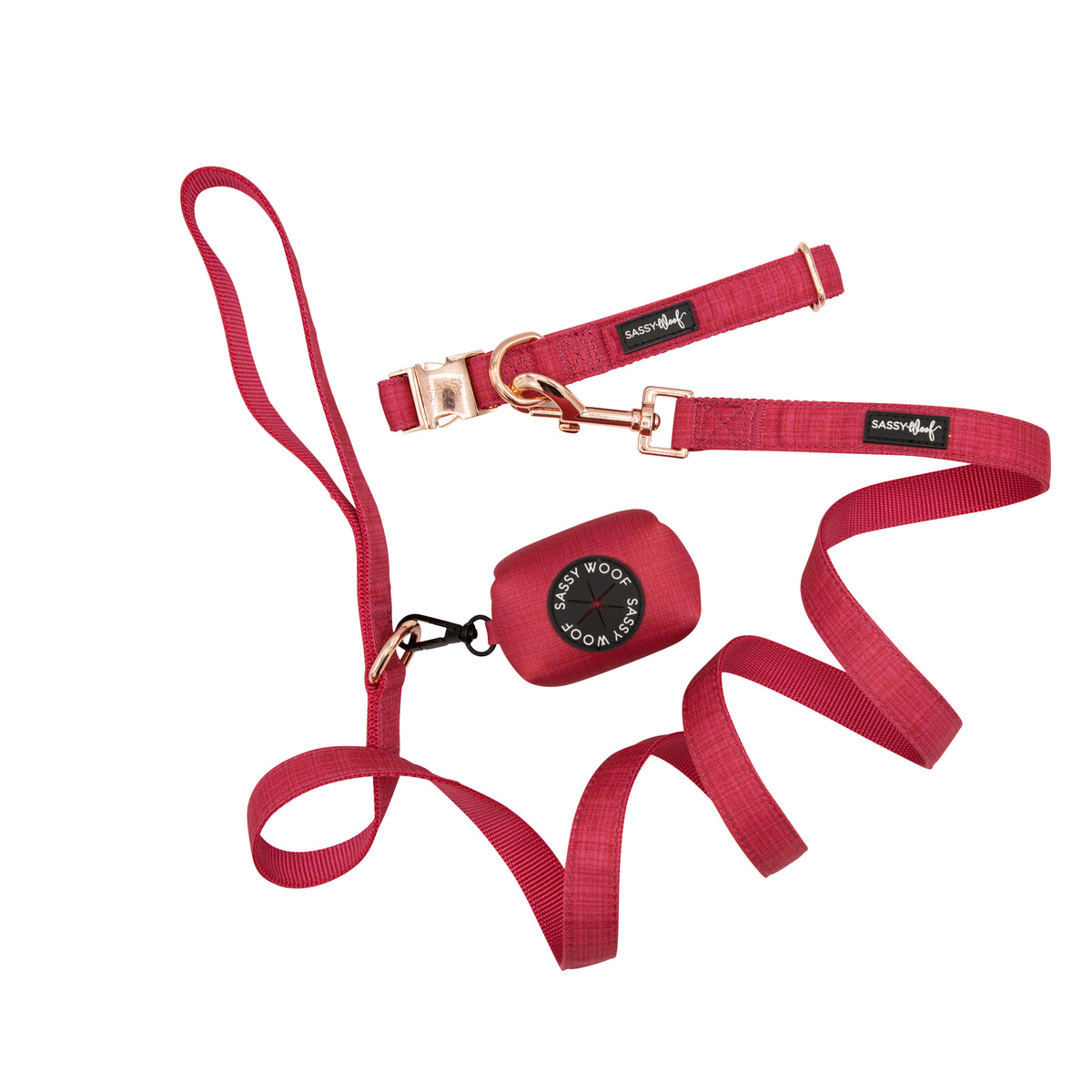 The Sassy Woof Collar Three Piece Bundle - Merlot features a matching red dog leash and collar set with gold-tone hardware and black Sassy Woof fabric tags, displayed on a white background.