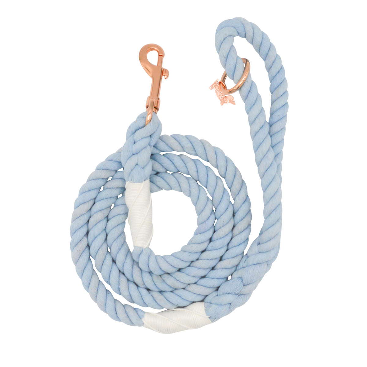 The Sassy Woof Dog Rope Leash - Azul is a coiled light blue cotton leash with white accents, featuring a rose gold clip and a small rose gold dog-shaped charm near the handle.