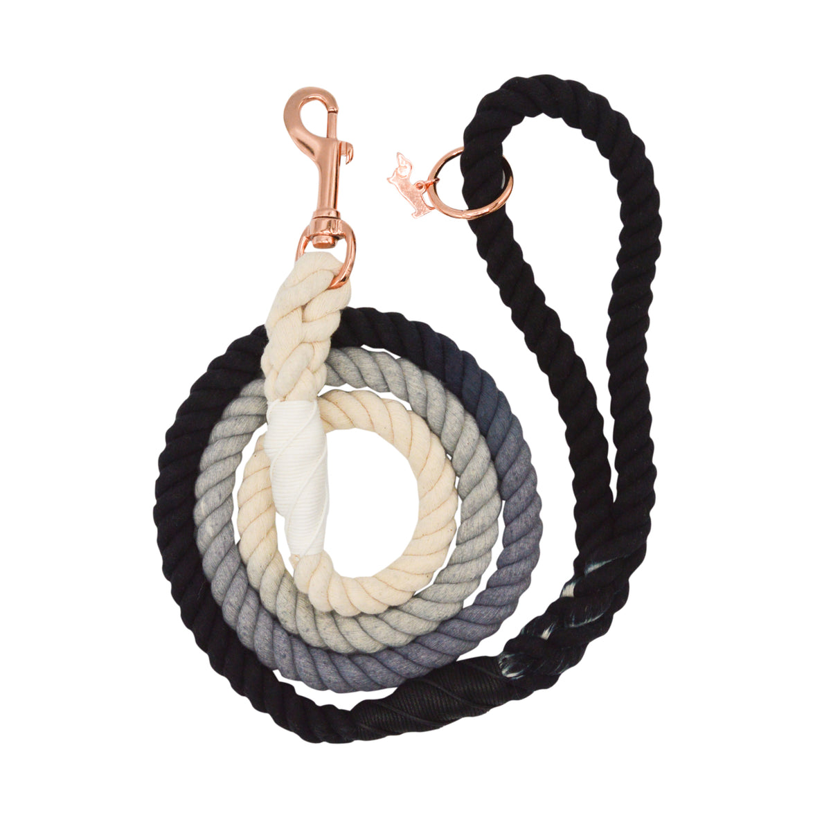 The Sassy Woof Dog Rope Leash - Ombre Black is a hand-crafted leash with rose gold hardware, featuring a coiled design and a smooth cream-to-gray-to-black gradient.