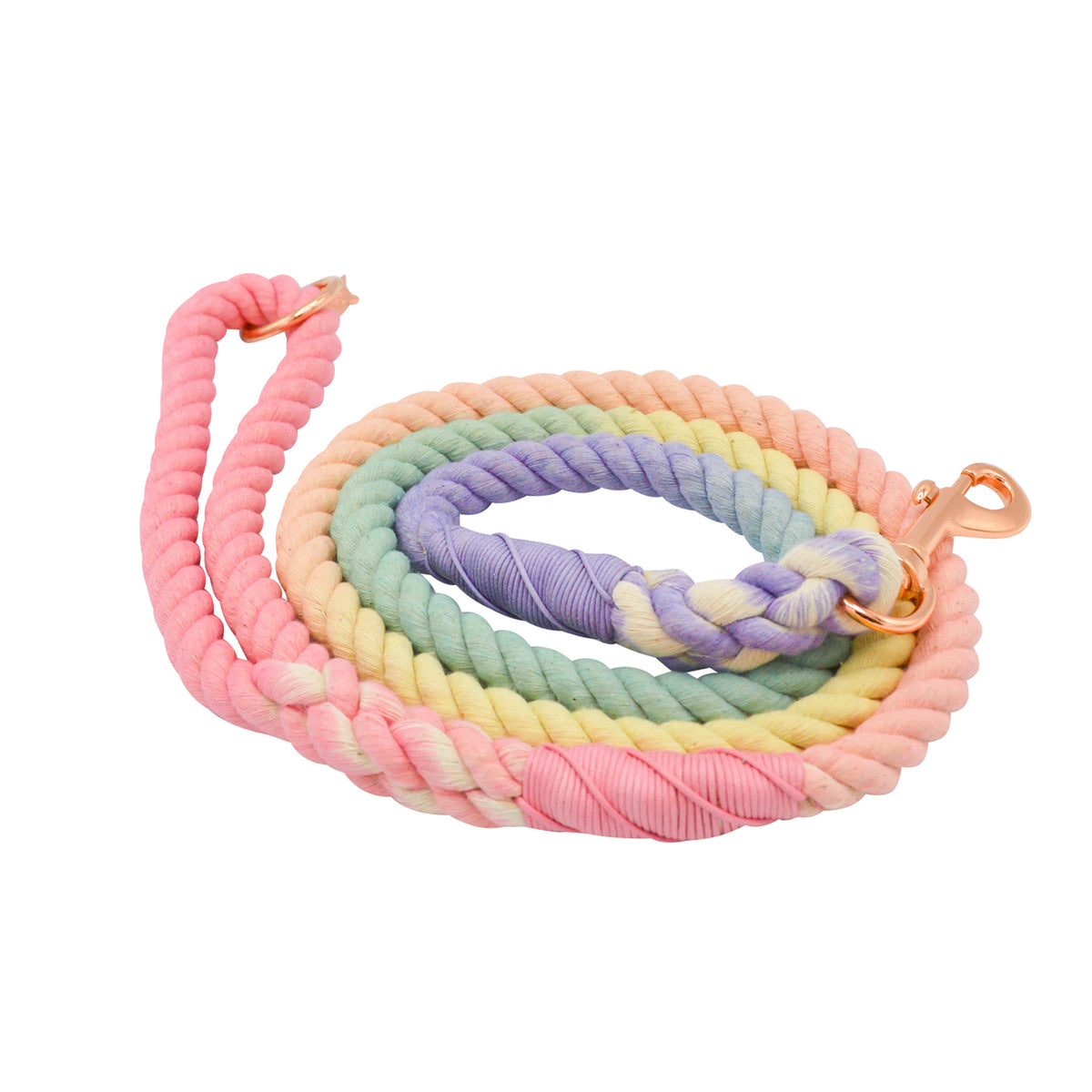 The Sassy Woof Dog Rope Leash - Rainbow Bright features a cotton rope design with rose gold hardware and a pastel rainbow gradient of pink, yellow, green, and purple on a white background.