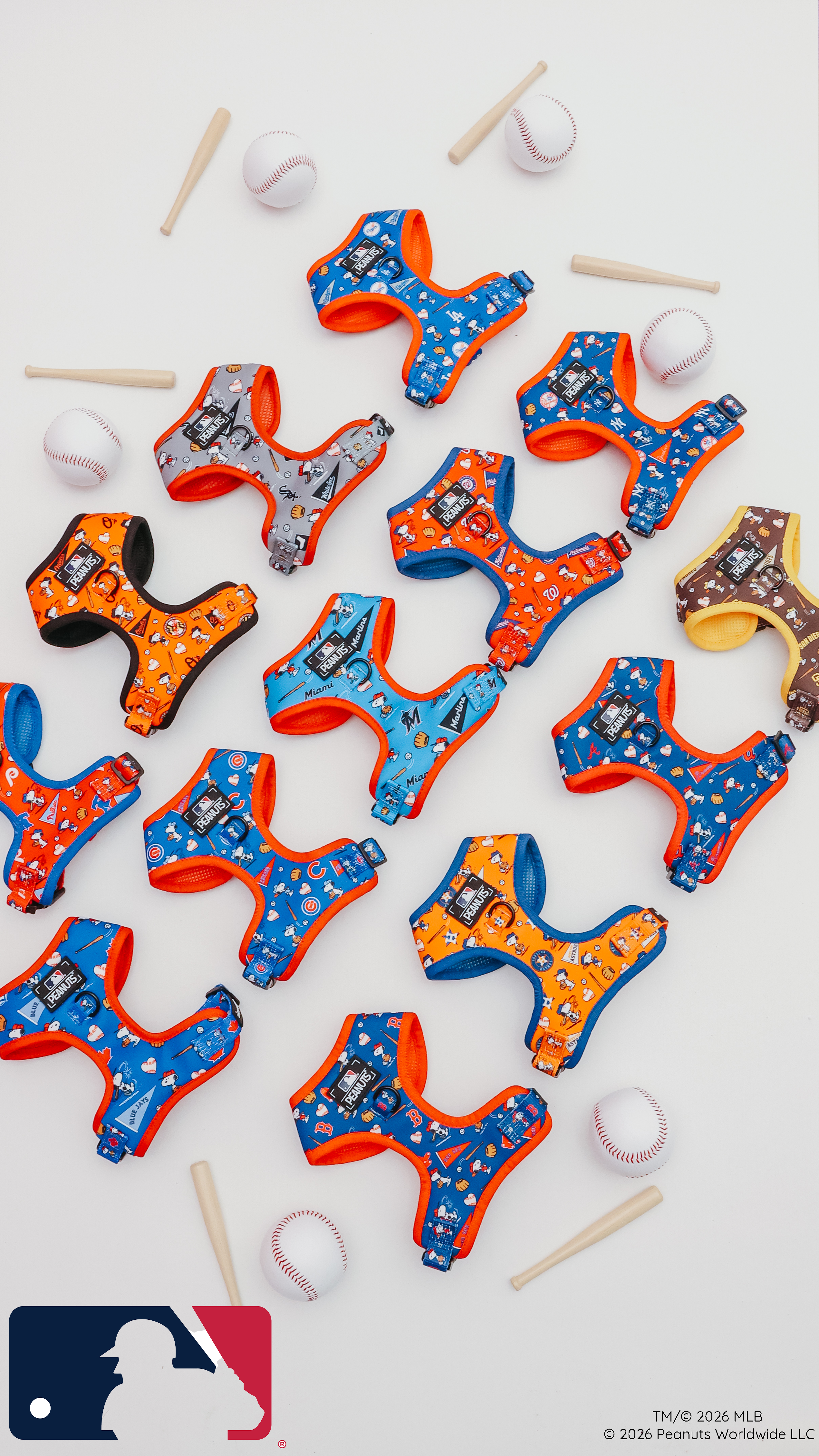 Colorful dog harnesses with various cartoon and baseball team designs are arranged neatly on a white background, surrounded by small baseball bats, baseballs, and the MLB logo in the bottom left corner.