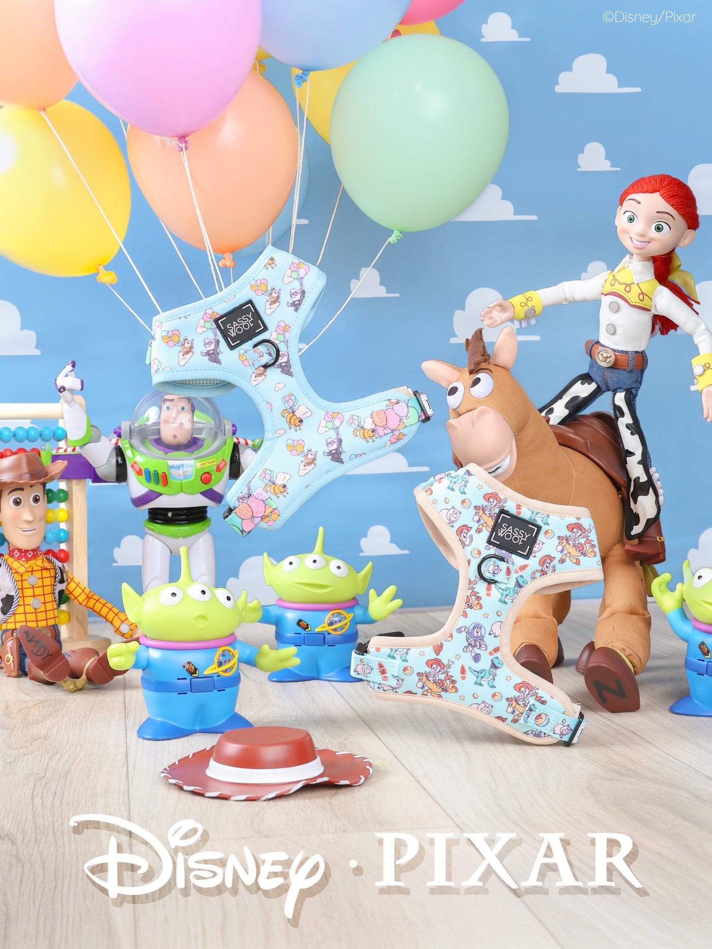 Toy Story characters Woody, Buzz Lightyear, Jessie, Bullseye, and Little Green Men are surrounded by balloons and large decorative letters 1 against a blue sky backdrop with clouds. Disney Pixar logo is at the bottom.