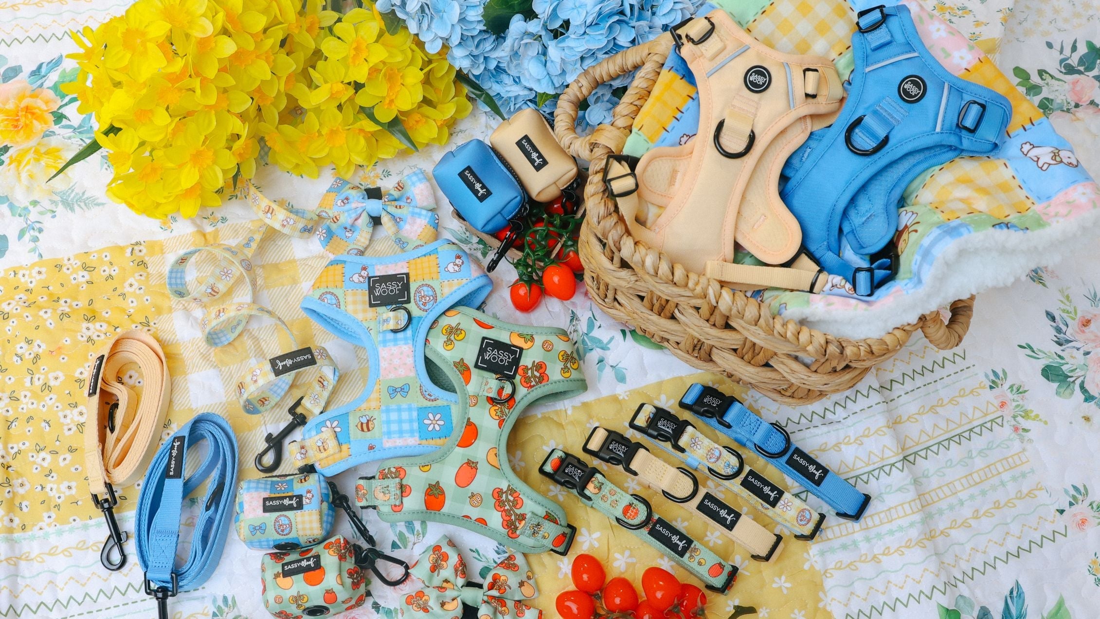 A dog’s front paws are visible on a blanket decorated with Winnie the Pooh characters and camping items. A matching leash with cartoon designs lies in a loose loop on the blanket.