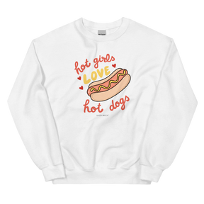 The Sassy Woof Sweatshirt - Hot Girls Love Hot Dogs is a comfy white unisex crewneck featuring a cartoon hot dog, playful red and yellow hearts, and bold "hot girls love hot dogs" text—perfect for loungewear.