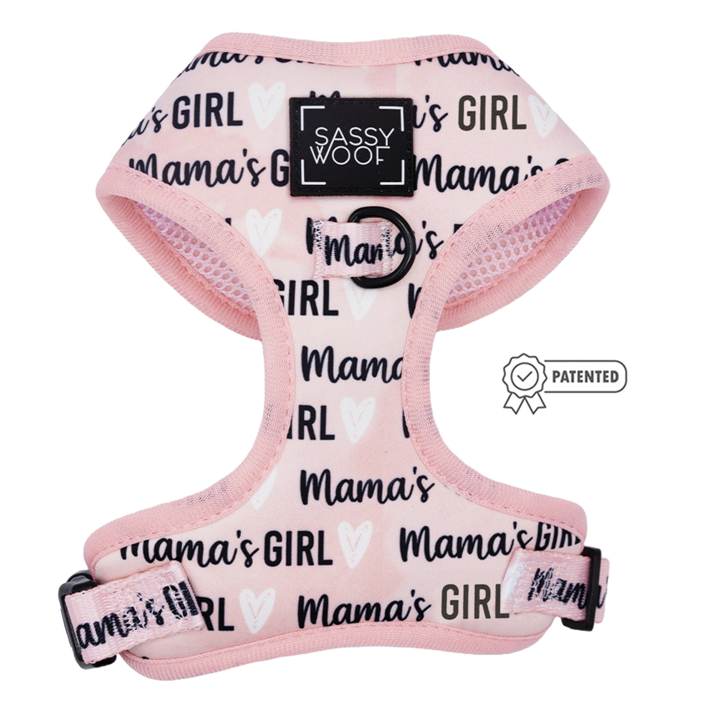The Dog Adjustable Harness - Mama's Girl by Sassy Woof is pink, features repeated black and white "Mama's Girl" text, a Sassy Woof logo on the chest, and a patented badge on the right side.
