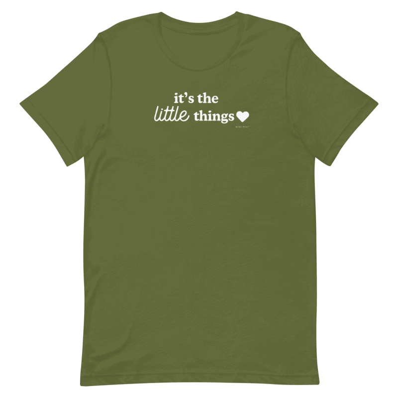 The Sassy Woof Human Tee - It's the Little Things is an olive green unisex shirt made of 100% ring-spun cotton, showcasing white "it's the little things" text with a heart on the chest, printed with eco-friendly ink.
