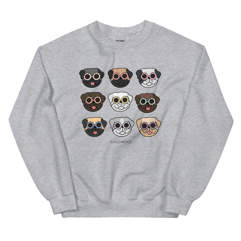 The Sassy Woof Sweatshirt - Pugs is a comfy unisex gray crewneck featuring nine cartoon dog faces, including a playful pug in colorful sunglasses, with “SASSY WOOF” printed below the grid.