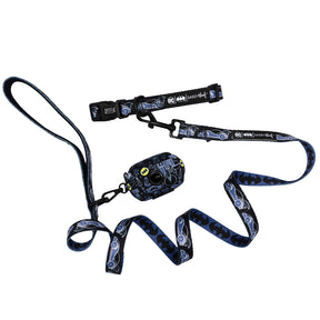 The Sassy Woof Dog Collar Three Piece Bundle - Batman™ features a blue and black collar, harness, and leash set with yellow accents, showcasing Batmobile and bat symbol designs. This stylish DC x Sassy Woof collection is displayed on a white background.