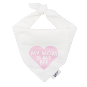 The Sassy Woof Dog Bandana - My Mom is my BFF (PINK) is a lightweight white cotton accessory with a pink heart, cute "MY MOM IS MY BFF" print, top tie closure, and a Sassy Woof tag on the edge.