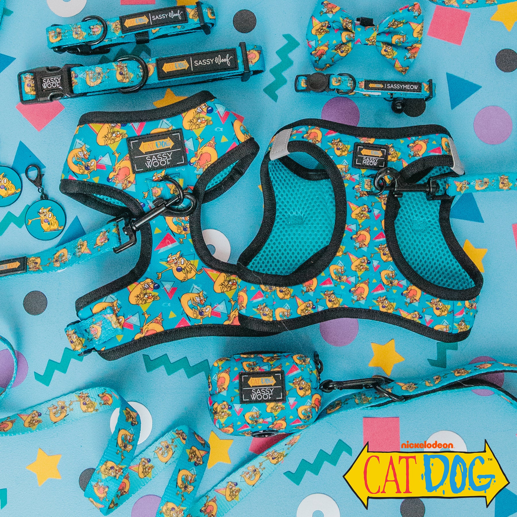 The Sassy Woof Collar Tag from the Nickelodeon CatDog™ collection sits on a colorful geometric background, featuring playful cartoon dog designs and the CatDog logo.