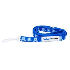 The Dog Leash - Care Bears™ Grumpy Bear by Sassy Woof features a blue design with cartoon bears and a white clasp—pairs perfectly with an adjustable collar or Care Bears harness for a coordinated look.