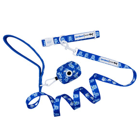 The Sassy Woof Collar Three Piece Bundle - Care Bears™ Grumpy Bear includes a blue collar with cartoon dog patterns, plastic buckle, brand label, matching leash, and waste bag holder—perfect to pair with other Grumpy Bear pet accessories.