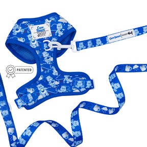 The Sassy Woof Dog Two Piece Bundle - Care Bears™ Grumpy Bear features a blue adjustable harness and leash set with Care Bears and cloud design, white plastic buckle, “Care Bears Sassy Woof” label, and silver badge icon—ideal for fans.