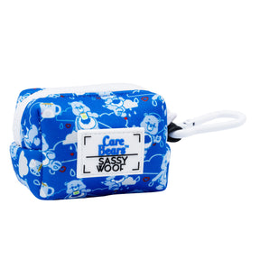 The Sassy Woof Dog Waste Bag Holder - Care Bears™ Grumpy Bear is a blue pouch with white cartoon bears and cloud patterns, a white zipper, and clip—perfect to match with a durable neoprene dog harness from the collection.