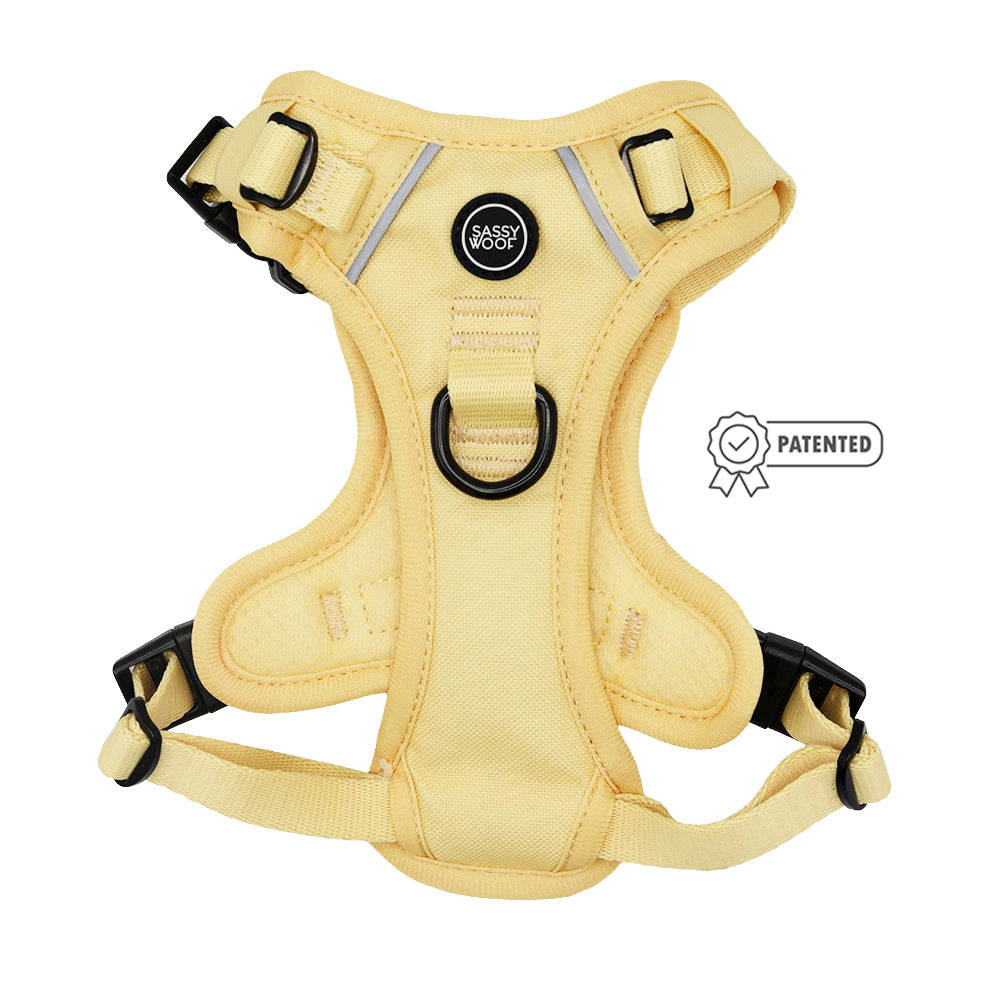 The Sassy Woof Dog Two Piece Bundle - Daffodil, featuring black buckles and rings, is shown on a white background with a “Patented” ribbon icon beside the bright step-in harness.
